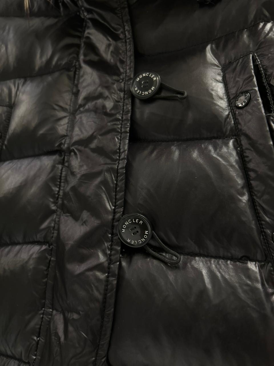 Moncler Women's down puffer jacket with a fur-trimmed hood.