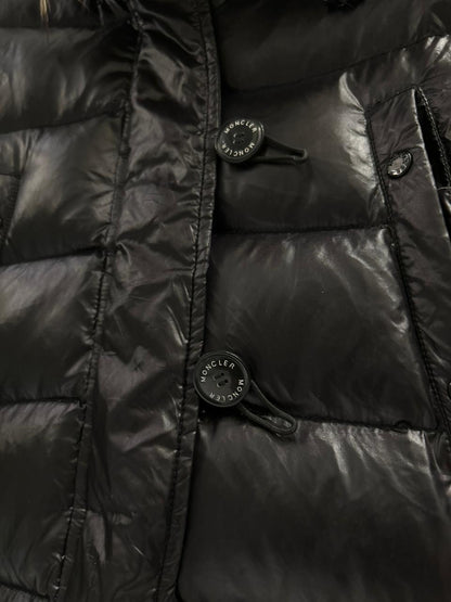 Moncler Women's down puffer jacket with a fur-trimmed hood.