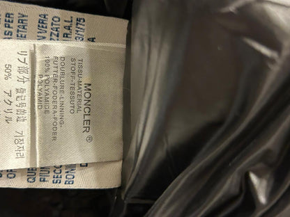 Moncler Women's down puffer jacket with a fur-trimmed hood.