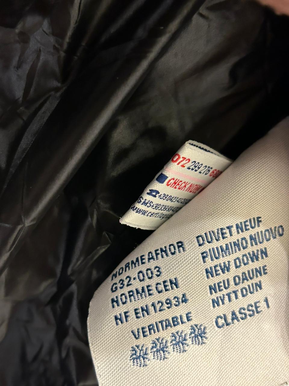 Moncler Women's down puffer jacket with a fur-trimmed hood.