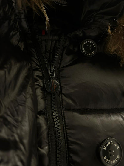 Moncler Women's down puffer jacket with a fur-trimmed hood.