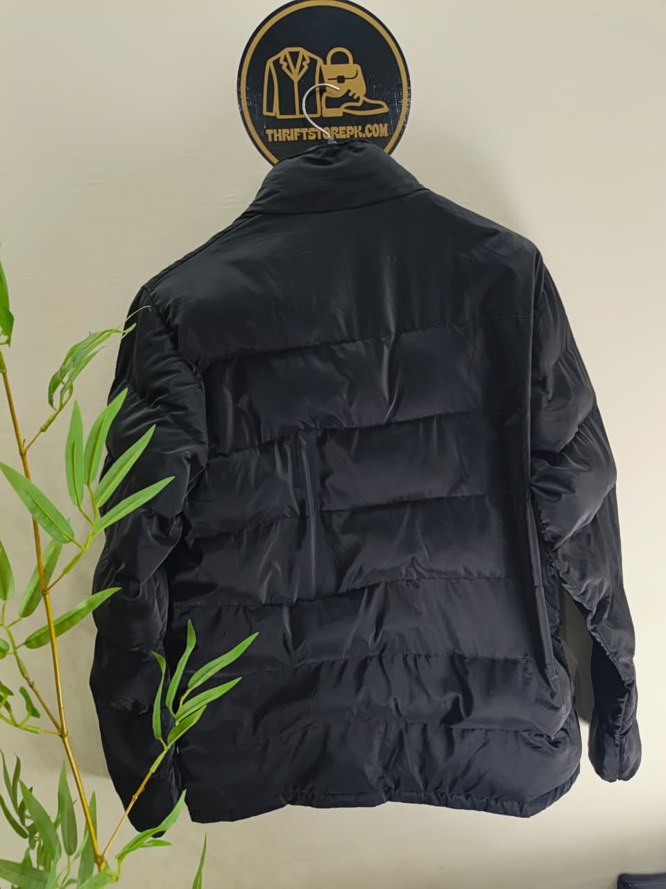 Prada-style black puffer jacket (triangle logo)