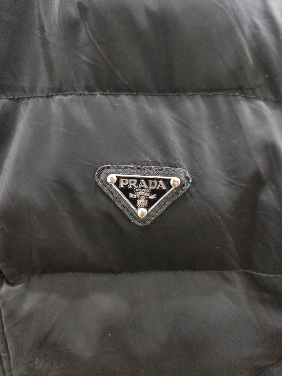 Prada-style black puffer jacket (triangle logo)