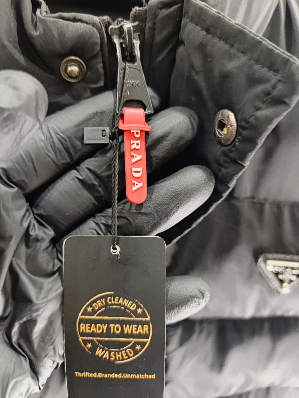 Prada-style black puffer jacket (triangle logo)