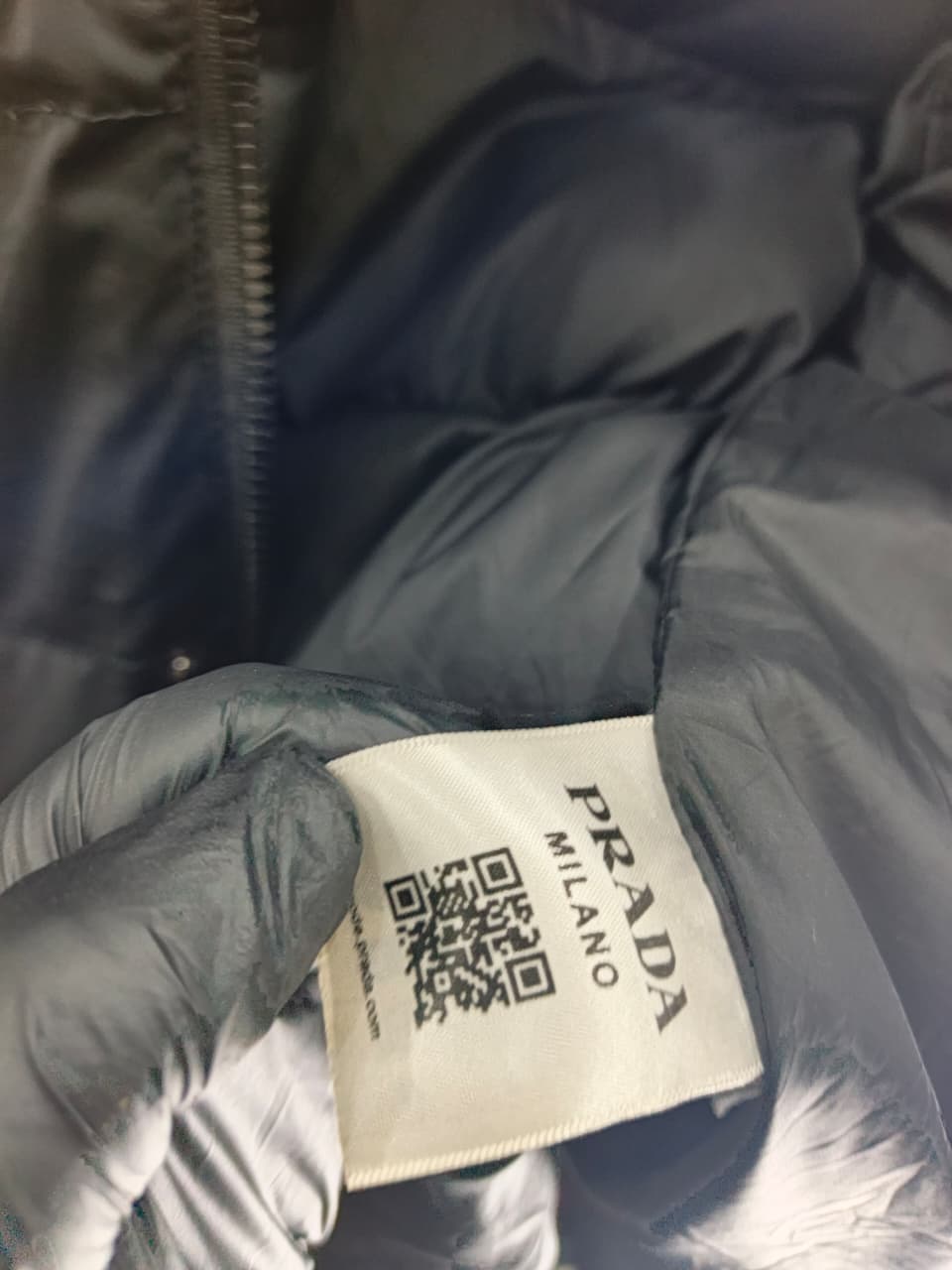 Prada-style black puffer jacket (triangle logo)