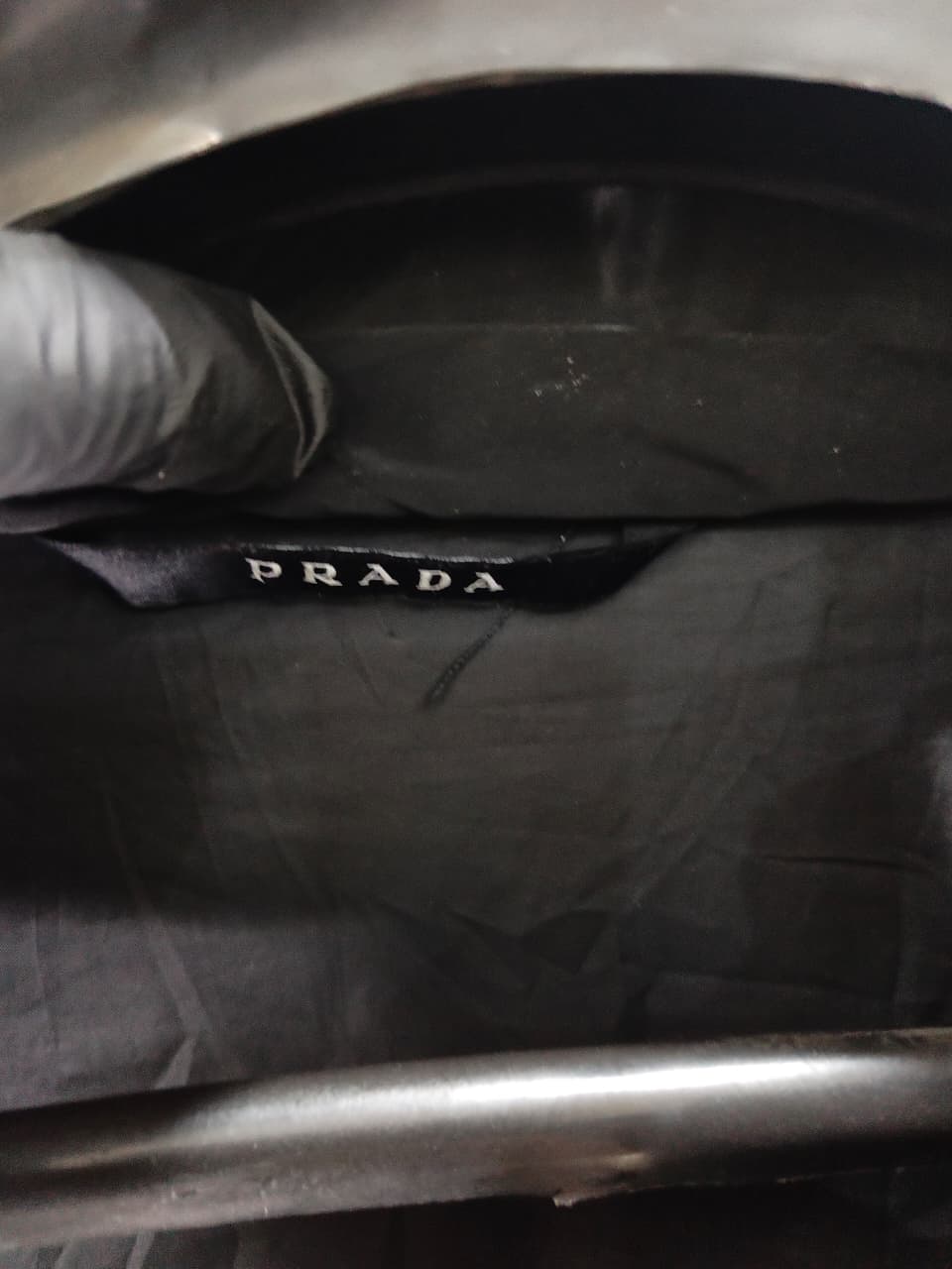 Prada-style black puffer jacket (triangle logo)