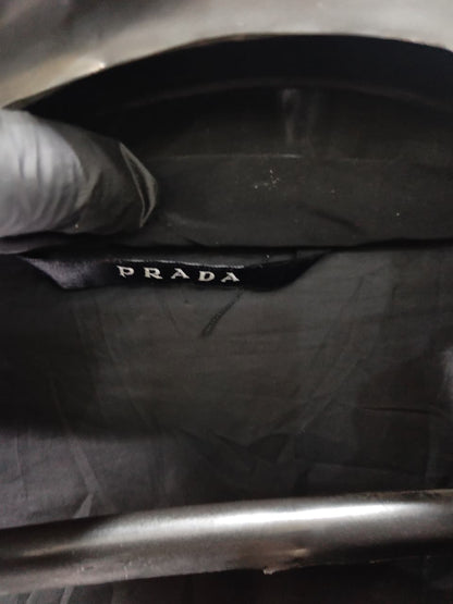 Prada-style black puffer jacket (triangle logo)